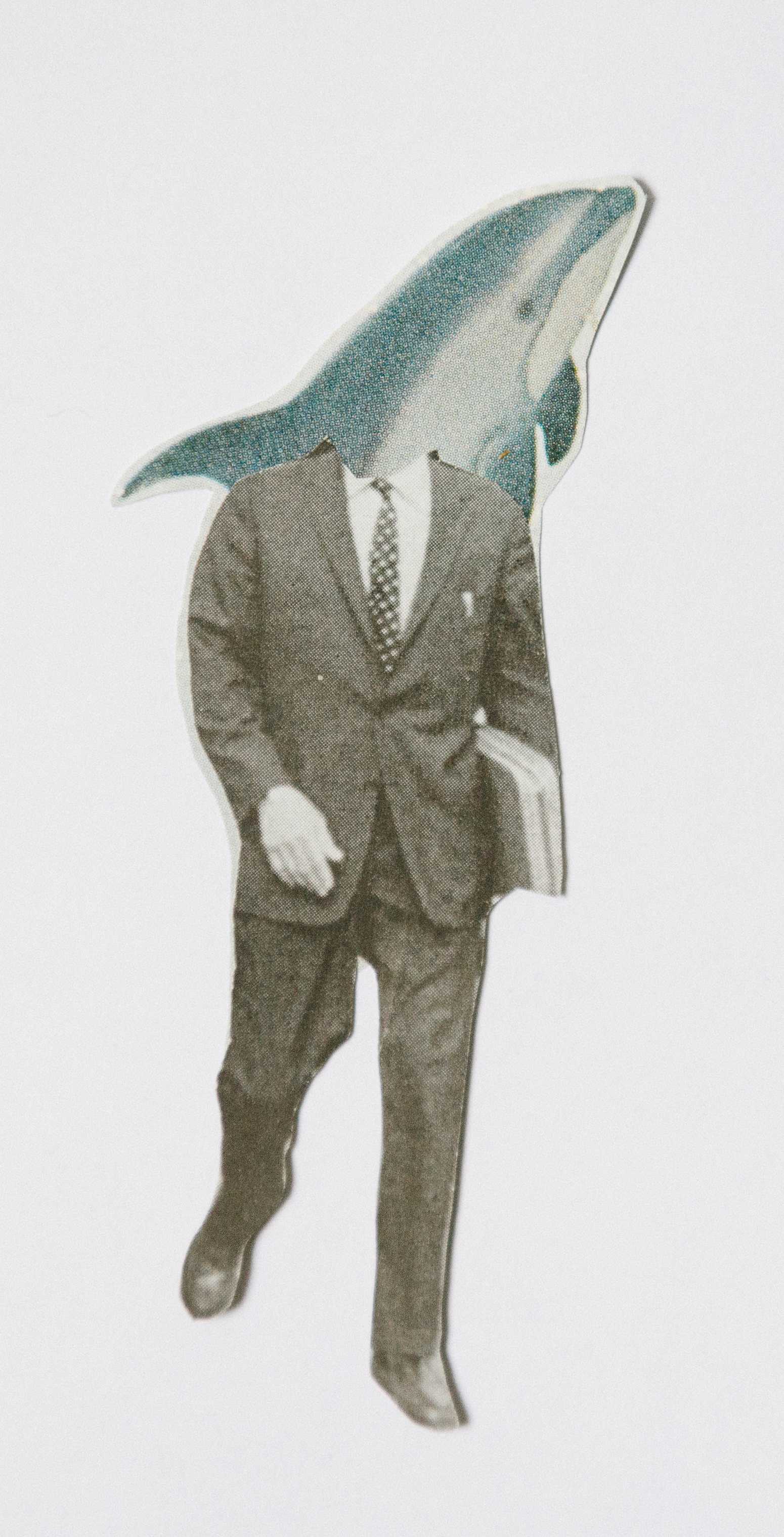 Man wearing a suit with a shark head